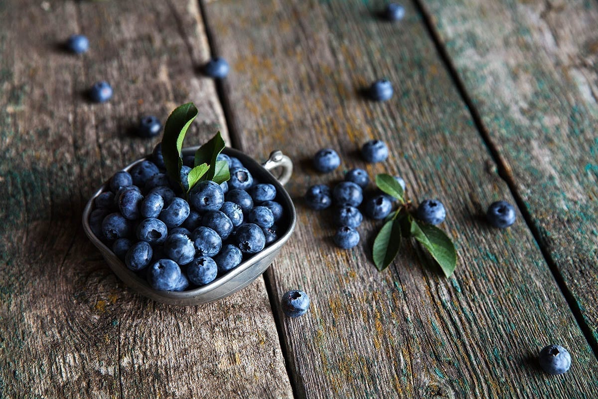 blueberry on a wooden background in a vintage bowl, berries, food Food, Restaurant, Bar & Lounge Photography - Website Design & Social Media Marketing - Palm Island Creative