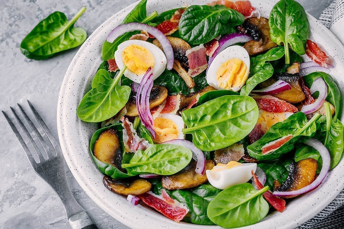 lunch bowl of spinach salad with bacon, mushrooms, eggs and red Food, Restaurant, Bar & Lounge Photography - Website Design & Social Media Marketing - Palm Island Creative